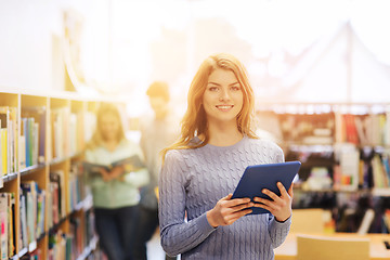 Image showing happy student girl with tablet pc in library