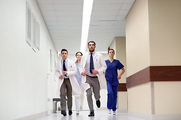 Image showing group of medics walking along hospital