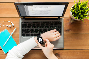 Image showing close up of woman with smart watch and laptop