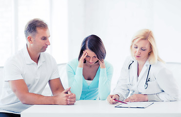 Image showing doctor with patients in cabinet