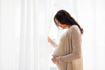 Image showing close up of happy pregnant woman with big belly