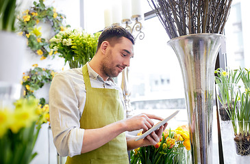 Image showing man with tablet pc computer at flower shop