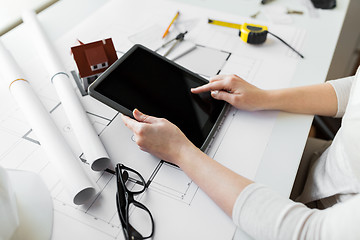 Image showing close up of hand with blueprint and tablet pc