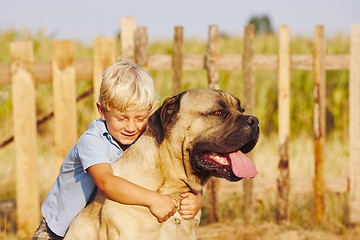 Image showing Little boy with large dog