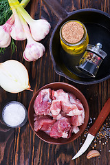 Image showing raw meat and pan on a table