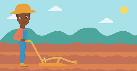 Image showing Farmer on the field with plough.