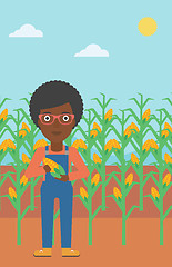 Image showing Farmer holding corn.