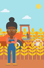 Image showing Woman standing with combine on background.