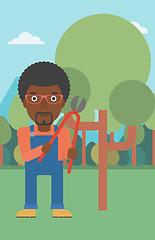 Image showing Farmer with pruner in garden.