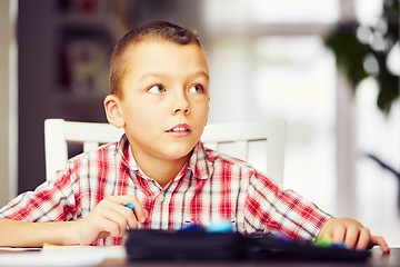 Image showing Boy is doing homework 