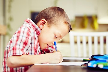 Image showing Boy is doing homework 