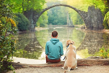 Image showing Pensive man sitting with his dog