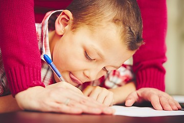 Image showing Boy is doing homework 