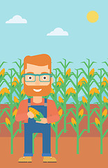 Image showing Farmer holding corn.