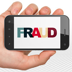 Image showing Security concept: Hand Holding Smartphone with Fraud on  display