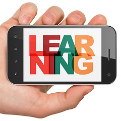 Image showing Studying concept: Hand Holding Smartphone with Learning on  display