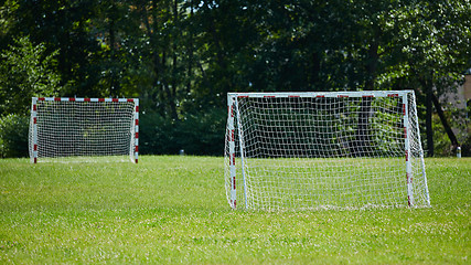 Image showing view of a net on vacant soccer pitch.
