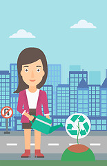Image showing Woman watering tree with recycle sign instead of crown.