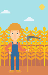 Image showing Farmer on the field with scythe.