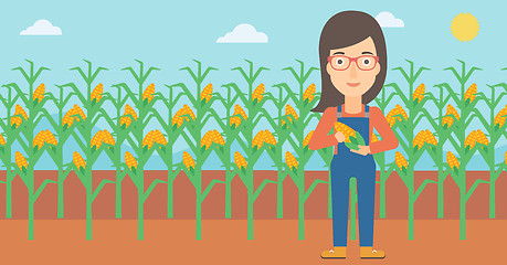 Image showing Farmer holding corn.