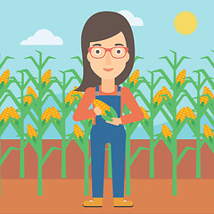 Image showing Farmer holding corn.