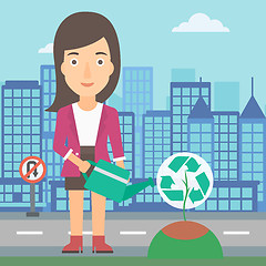 Image showing Woman watering tree with recycle sign instead of crown.