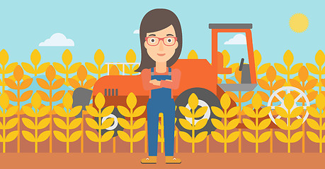 Image showing Woman standing with combine on background.