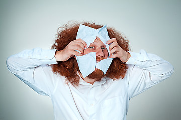 Image showing Angry man tear out paper