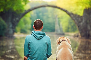 Image showing Pensive man sitting with his dog