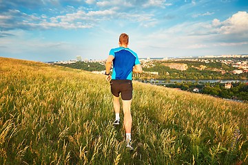 Image showing Athletic runner on the hillside