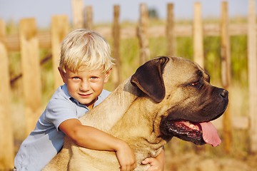 Image showing Little boy with large dog