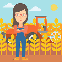 Image showing Woman standing with combine on background.