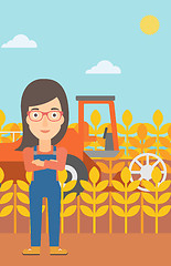 Image showing Woman standing with combine on background.