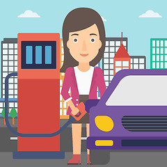 Image showing Woman filling up fuel into car.