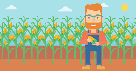 Image showing Farmer holding corn.