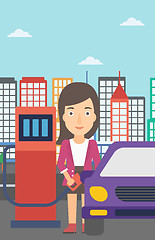 Image showing Woman filling up fuel into car.