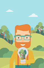 Image showing Man with lightbulb and trees inside.