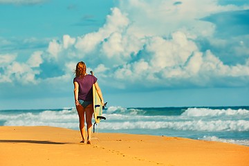 Image showing Surfer girl an the beach