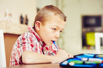 Image showing Boy is doing homework 