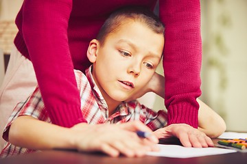 Image showing Boy is doing homework 