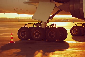 Image showing Wheels of the airplane at the sunset