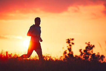 Image showing Athletic runner at the sunset