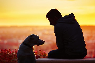 Image showing Man with dog at the sunrise