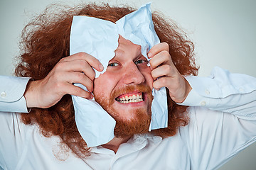 Image showing Angry man tear out paper