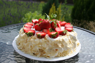 Image showing Midsummer gateau with strawberries, almond and cream