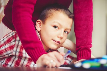 Image showing Boy is doing homework