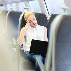 Image showing Woman sleeping while travelling by train.