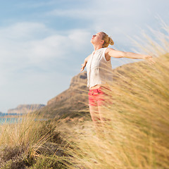 Image showing Free Happy Woman Enjoying Sun on Vacations.