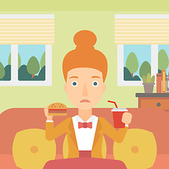 Image showing Woman eating hamburger. 