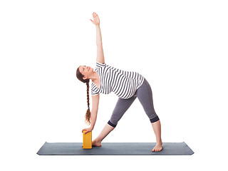 Image showing Pregnant woman doing yoga asana Utthita trikonasana